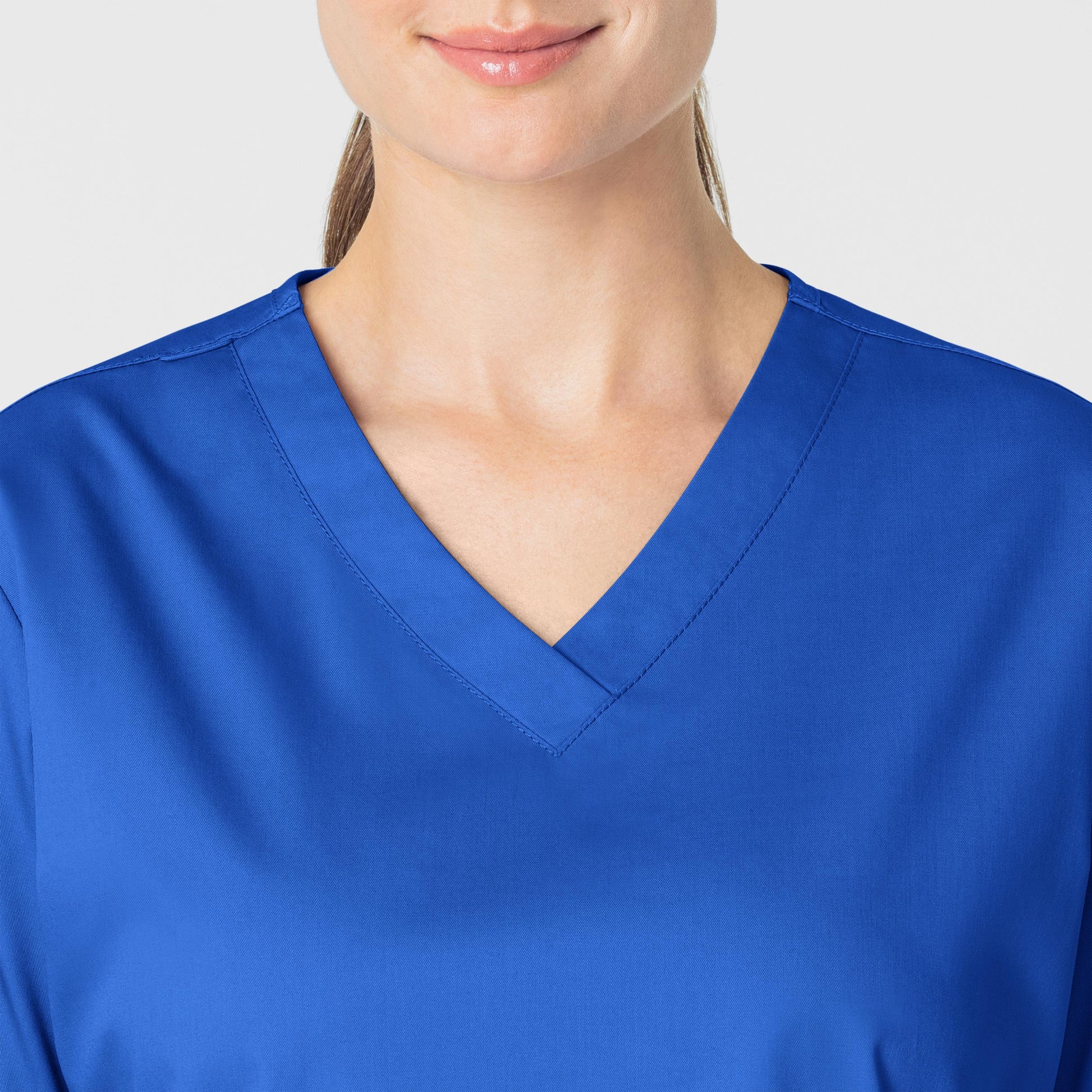 WonderWORK 101 V-Neck Scrub Top Royal Model Image Left Side | Wink