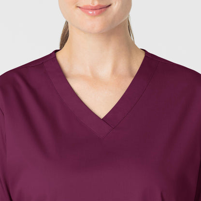 WonderWORK 101 V-Neck Scrub Top Wine Model Image Left Side | Wink