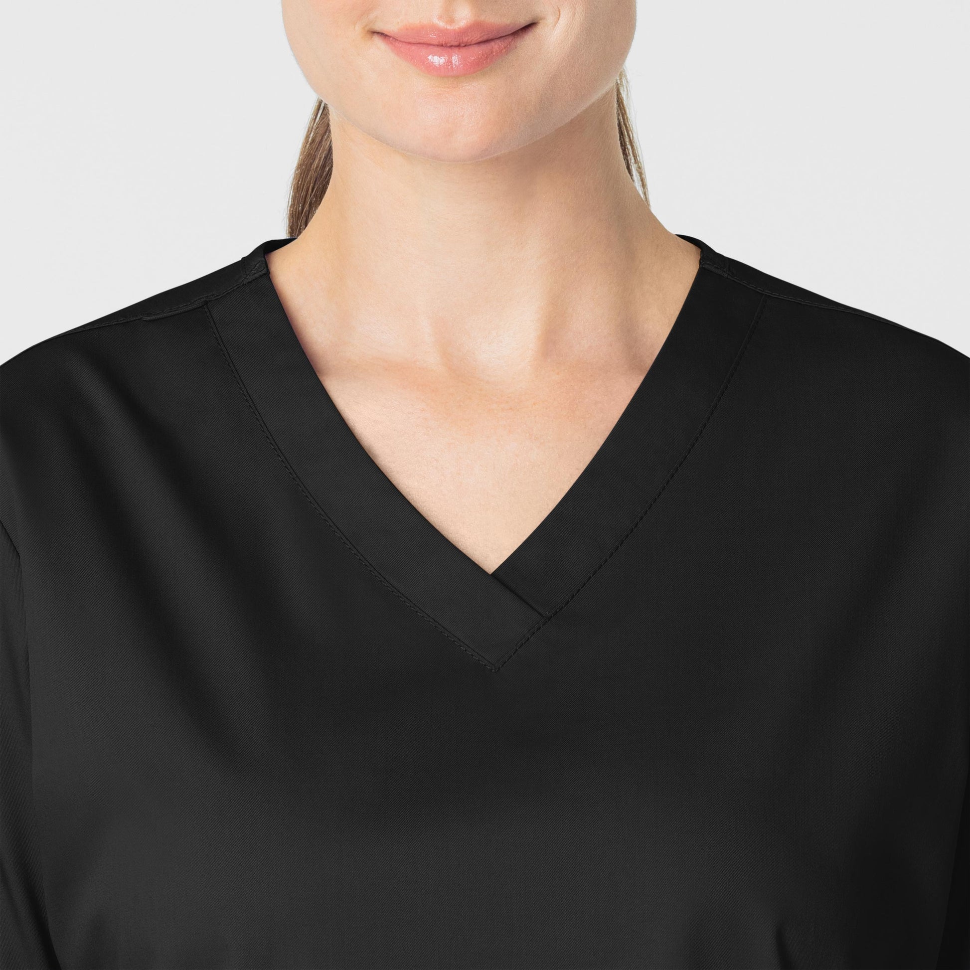 WonderWORK 101 V-Neck Scrub Top Black Model Image Left Side | Wink