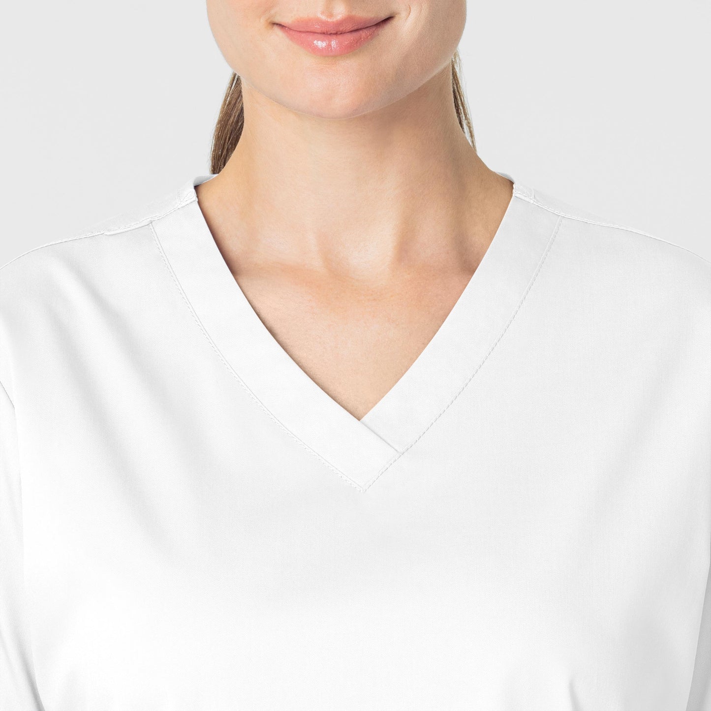 WonderWORK 101 V-Neck Scrub Top White Model Image Alternate | Wink