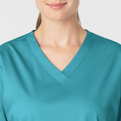 WonderWORK 101 V-Neck Scrub Top Teal Blue Model Image Left Side | Wink