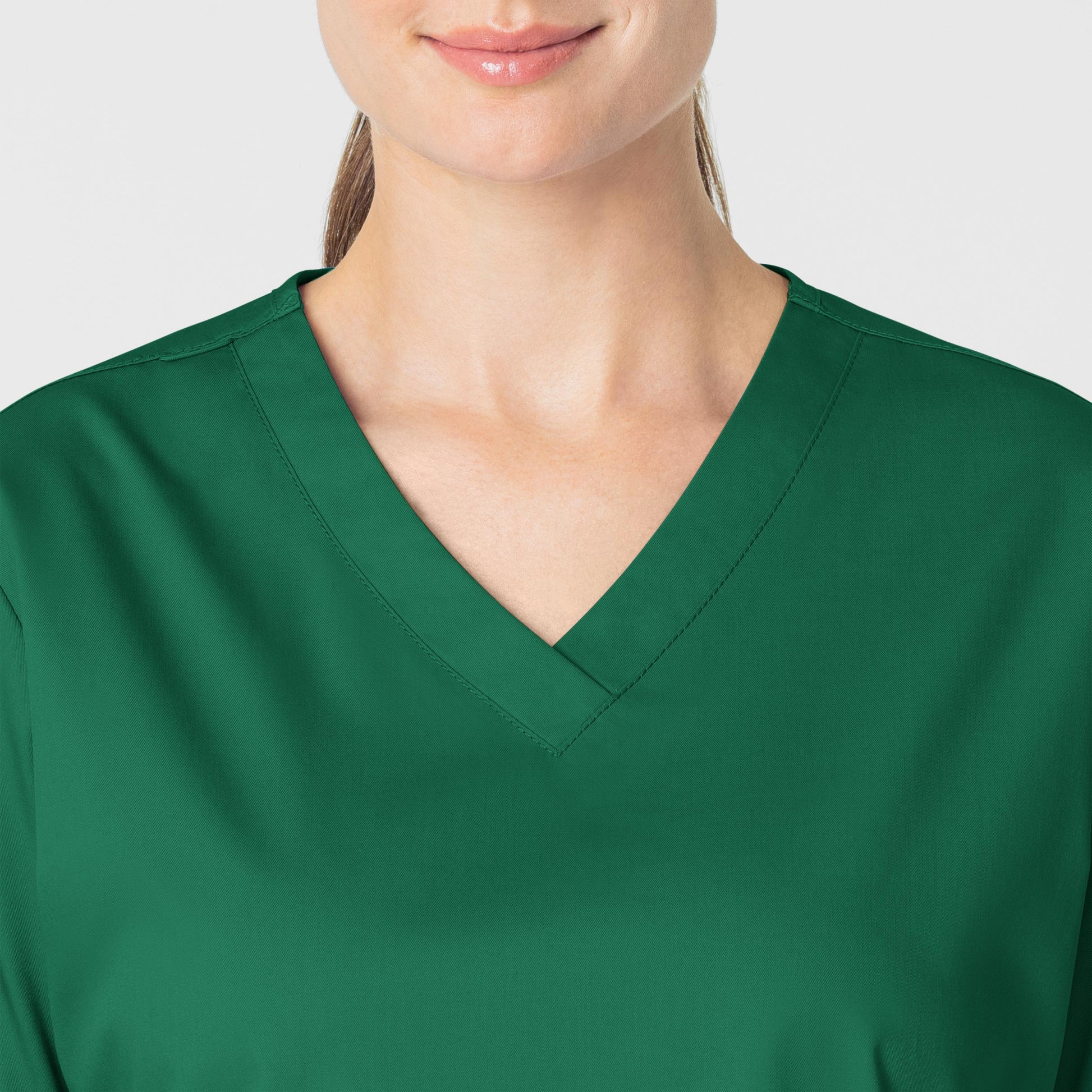 WonderWORK 101 V-Neck Scrub Top Hunter Model Image Left Side | Wink